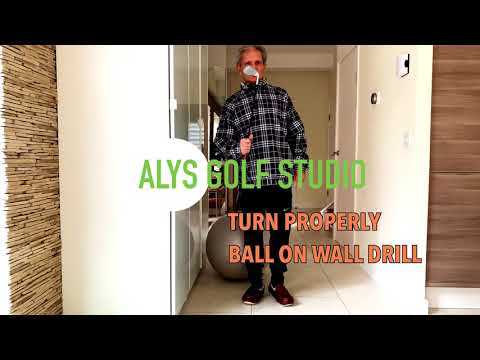 Better golf turn with ball on wall drill